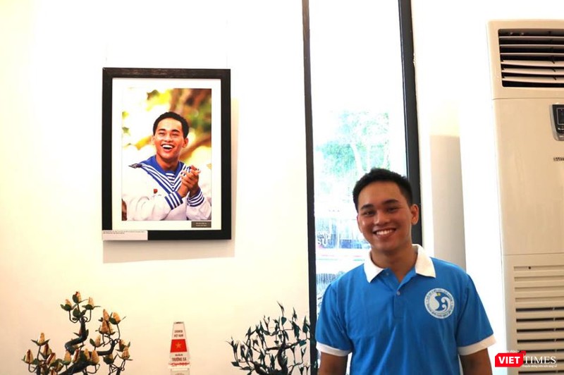Anh Nguyễn Văn Hiếu bên bức ảnh mà nhiếp ảnh gia Trần Thành đã chụp ngày anh đang là lính đảo Trường Sa