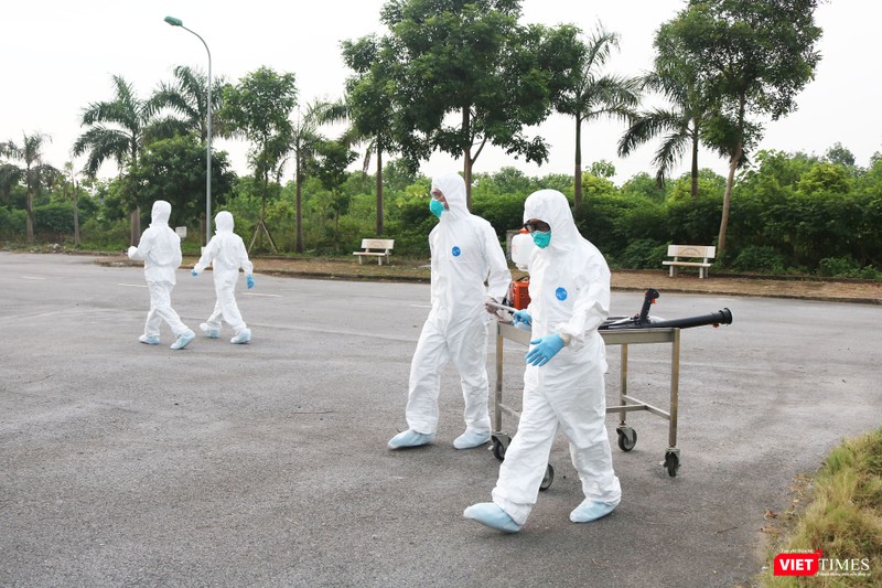 Nhân viên y tế chuẩn bị phun khử khuẩn phòng COVID-19 (Ảnh - Minh Thuý) 