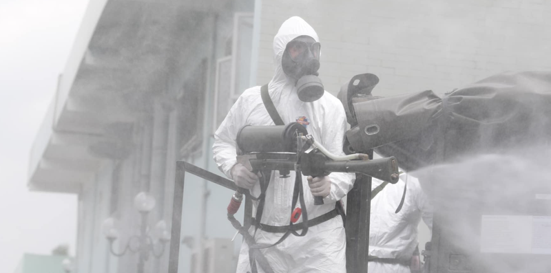 Nhân viên y tế phun khử khuẩn phòng COVID-19 (Ảnh - Hoàng Anh)