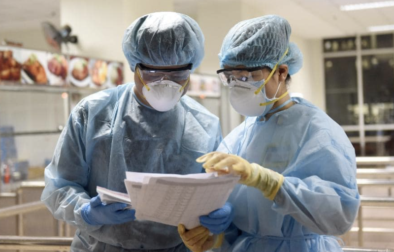 Bác sĩ kiểm tra thông tin của bệnh nhân COVID-19 (Ảnh - BYT) 