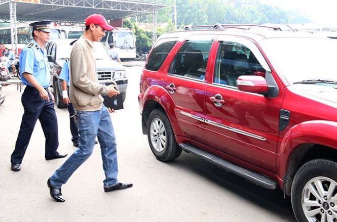 Thanh tra giao thông kiểm tra một chiếc taxi Uber tại khu vực đường Lê Hồng Phong, Q.5 - Ảnh: Tiến Long