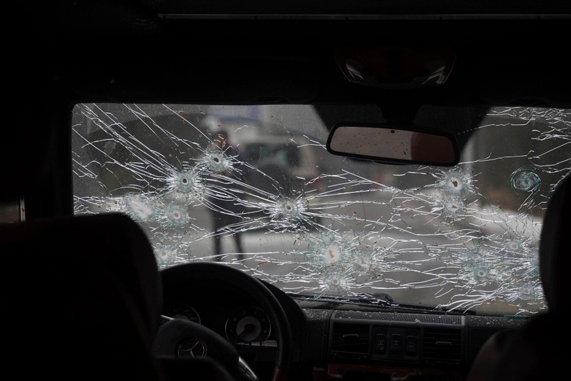 Một xe cảnh sát bị những người bạo loạn bắn trực diện với những vết đạn trên kính phía trước (Ảnh: AP).